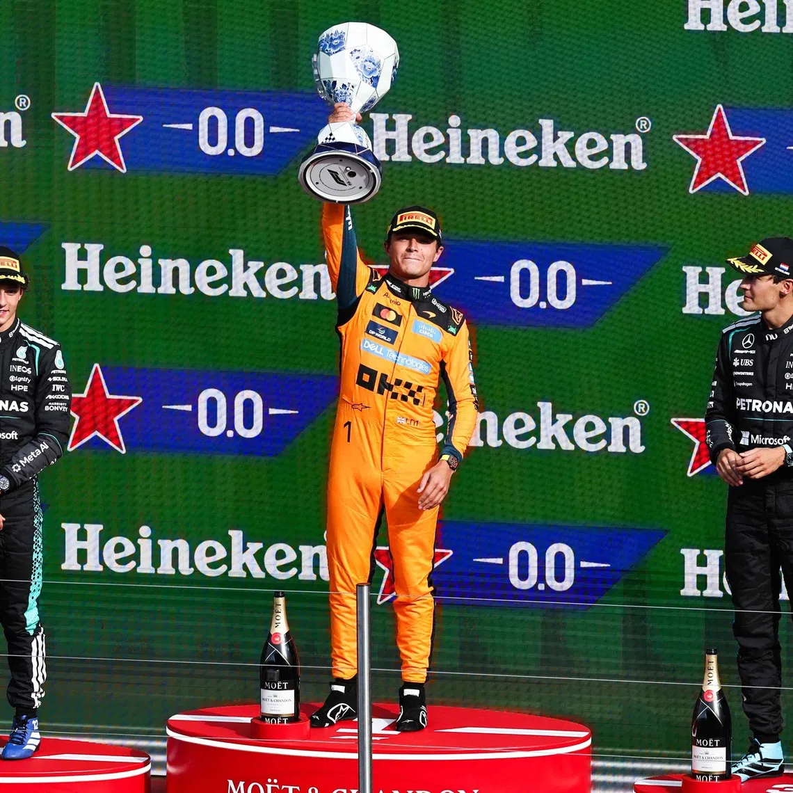 McLaren’s Lando Norris (centre) celebrates on the podium with Mercedes’ Kimi Antonelli (left) and George Russell after the Formula One Dutch Grand Prix on Aug 23.