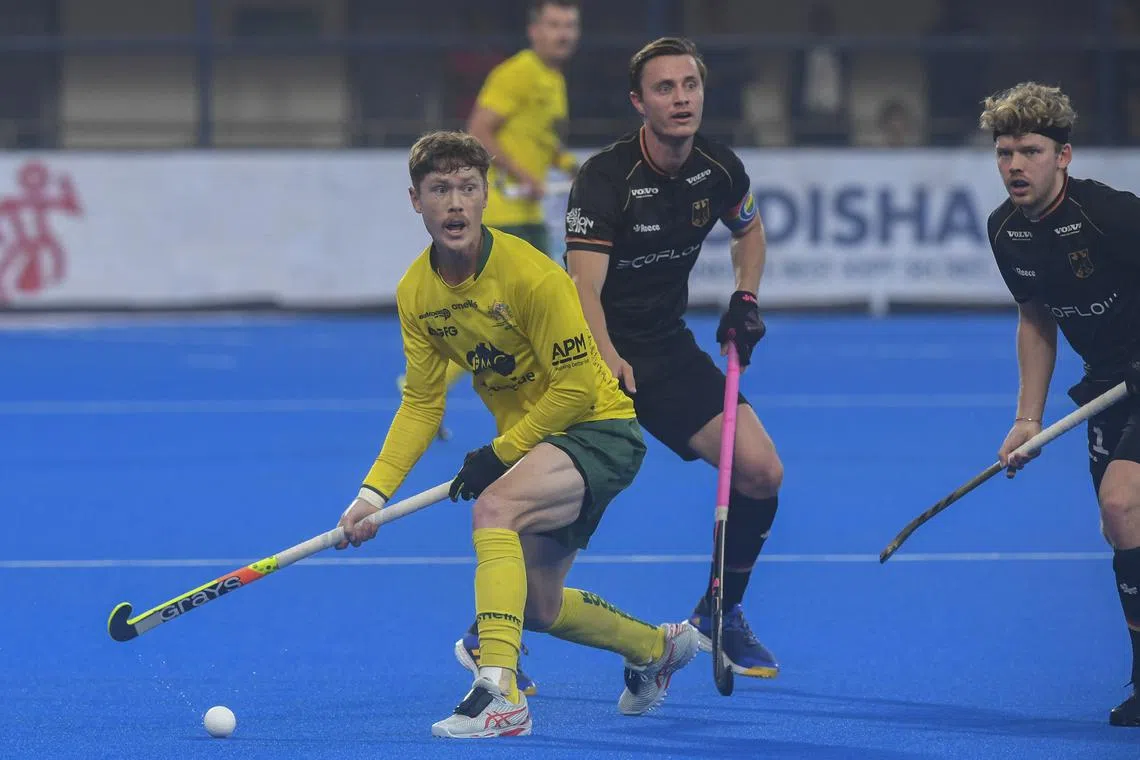 Australia's Matt Dawson (left) fights for the ball during the men's semi-final match at the FIH Odisha Field Hockey Men's World Cup 2023, in Bhubaneswar on Jan 27, 2023.