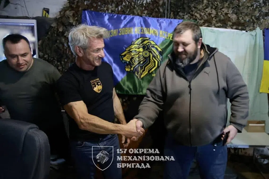 US actor Sean Penn (left) visiting soldiers of the 157th Separate Mechanised Brigade of Ukraine's armed forces.