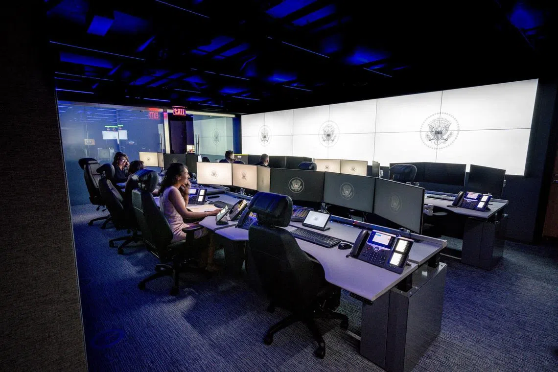 White House staff are seen seated in a part of the newly renovated White House Situation Room.