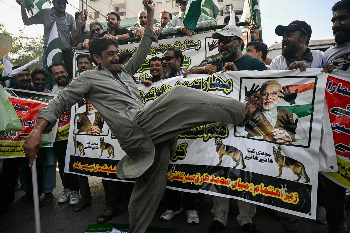 A trader kicking the picture of India’s Prime Minister Narendra Modi during an anti-India protest in Karachi, Pakistan, on April 29, 2025. 