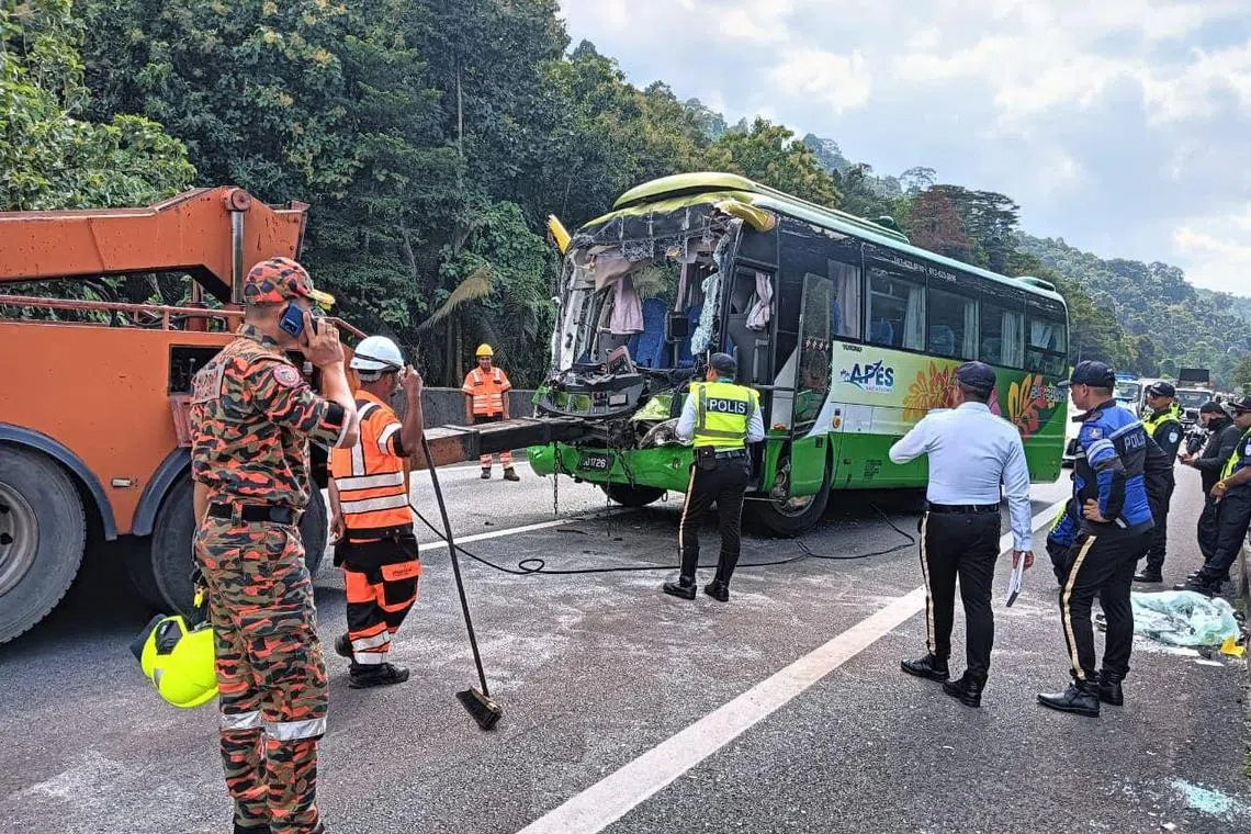 A firefighter and police stand at the site of a fatal road accident involving a bus, in Taiping, Perak, Malaysia, October 24, 2024. Perak Fire and Rescue Department (JBPM Perak)/Handout via REUTERS    THIS IMAGE HAS BEEN SUPPLIED BY A THIRD PARTY MANDATORY CREDIT. NO RESALES. NO ARCHIVES