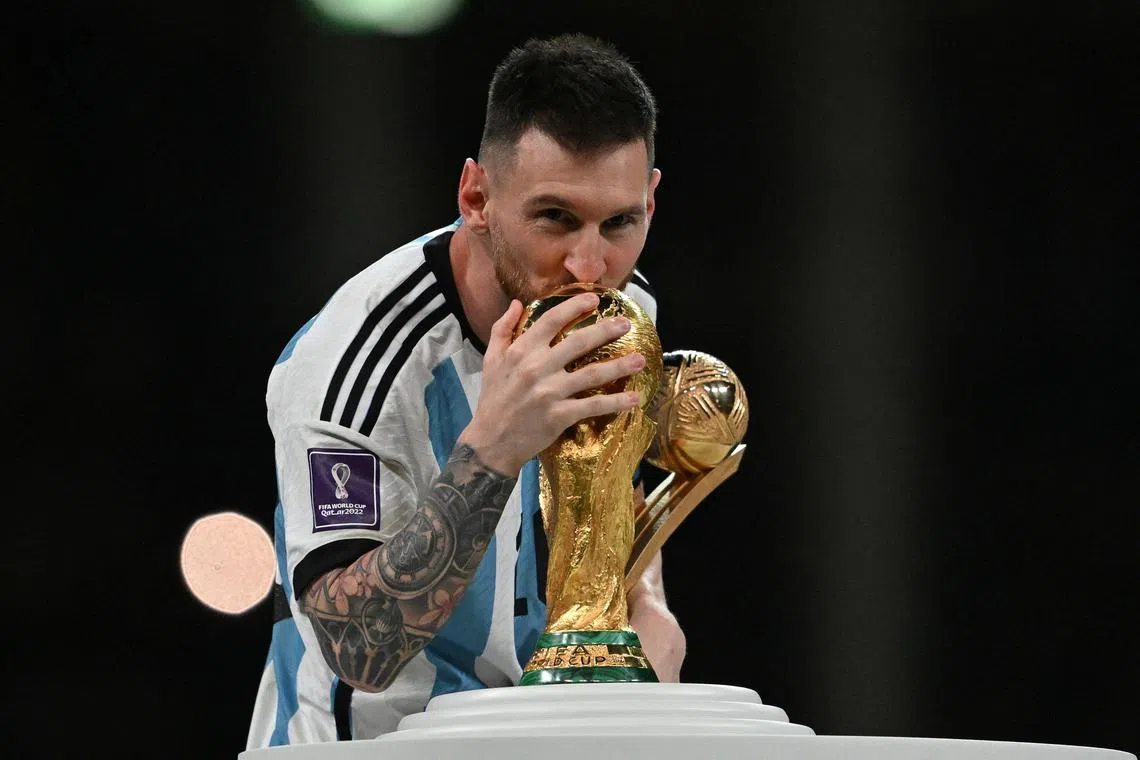 Lionel Messi kisses the Fifa World Cup trophy after Argentina won the Qatar 2022 World Cup final.