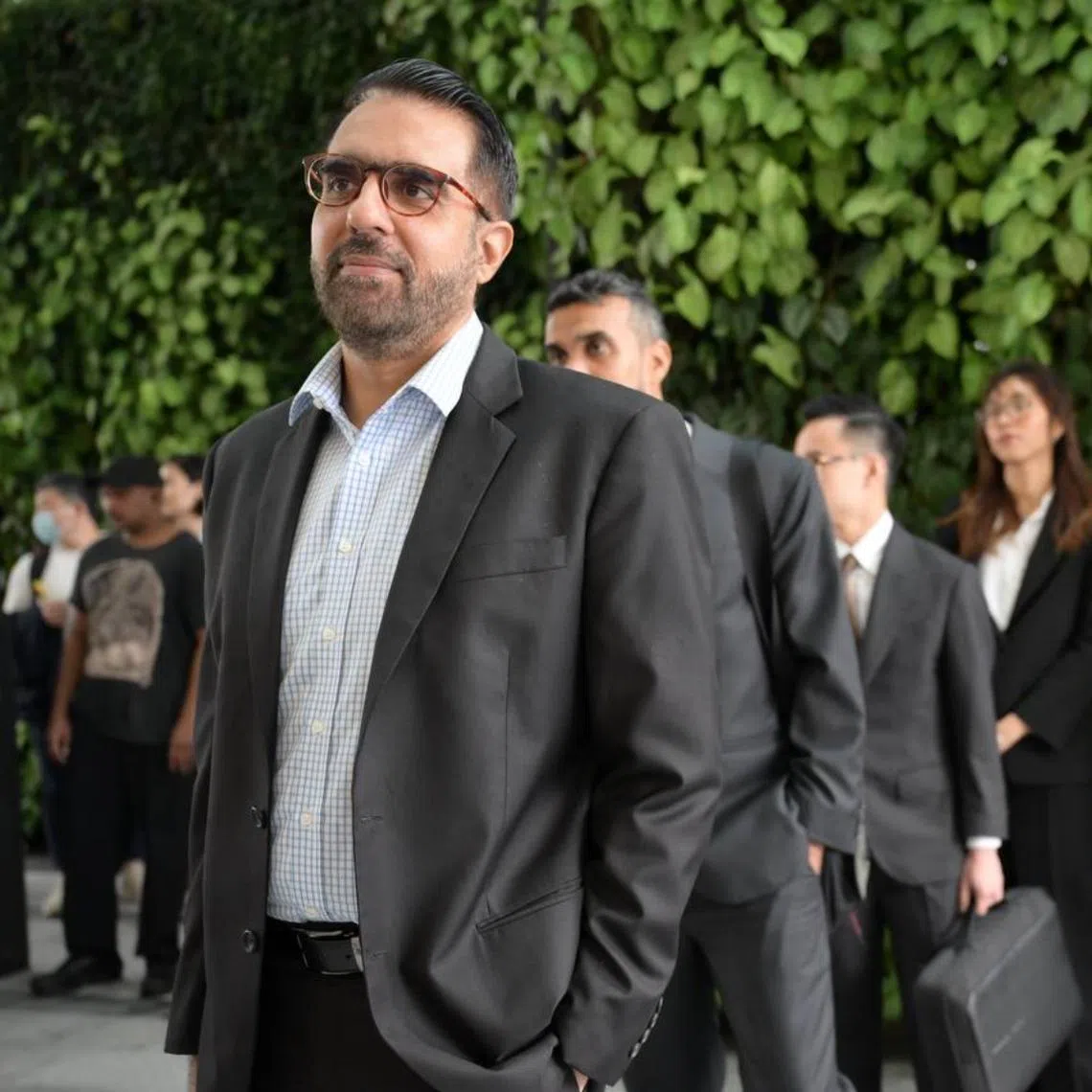 WP chief Pritam Singh queueing at the State Courts ahead his hearing on Nov 6.