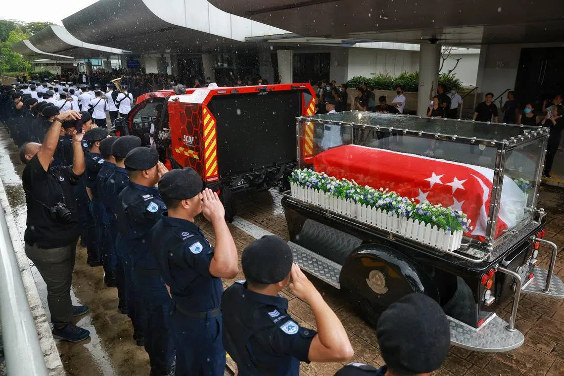 SCDF personnel saluting the hearse carrying the casket of Sgt (1) Edward H. Go at Mandai Crematorium on Dec 13, 2022. 