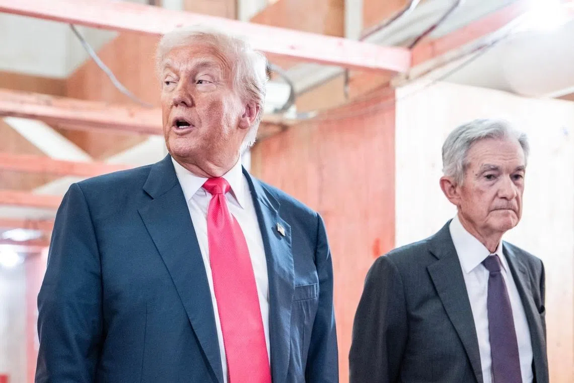 US President Donald Trump pointing to a cost sheet as he tours the Federal Reserve building under renovation with Fed chair Jerome Powell in July 2025. 