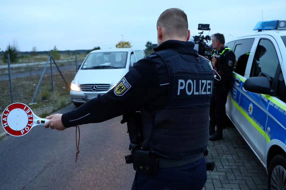FILE PHOTO: A German federal police Bundespolizei officers stops a vehicle during a patrol along the German-Polish border to prevent illegal migration near Forst, Germany, October 12, 2023. REUTERS/Fabrizio Bensch/File Photo