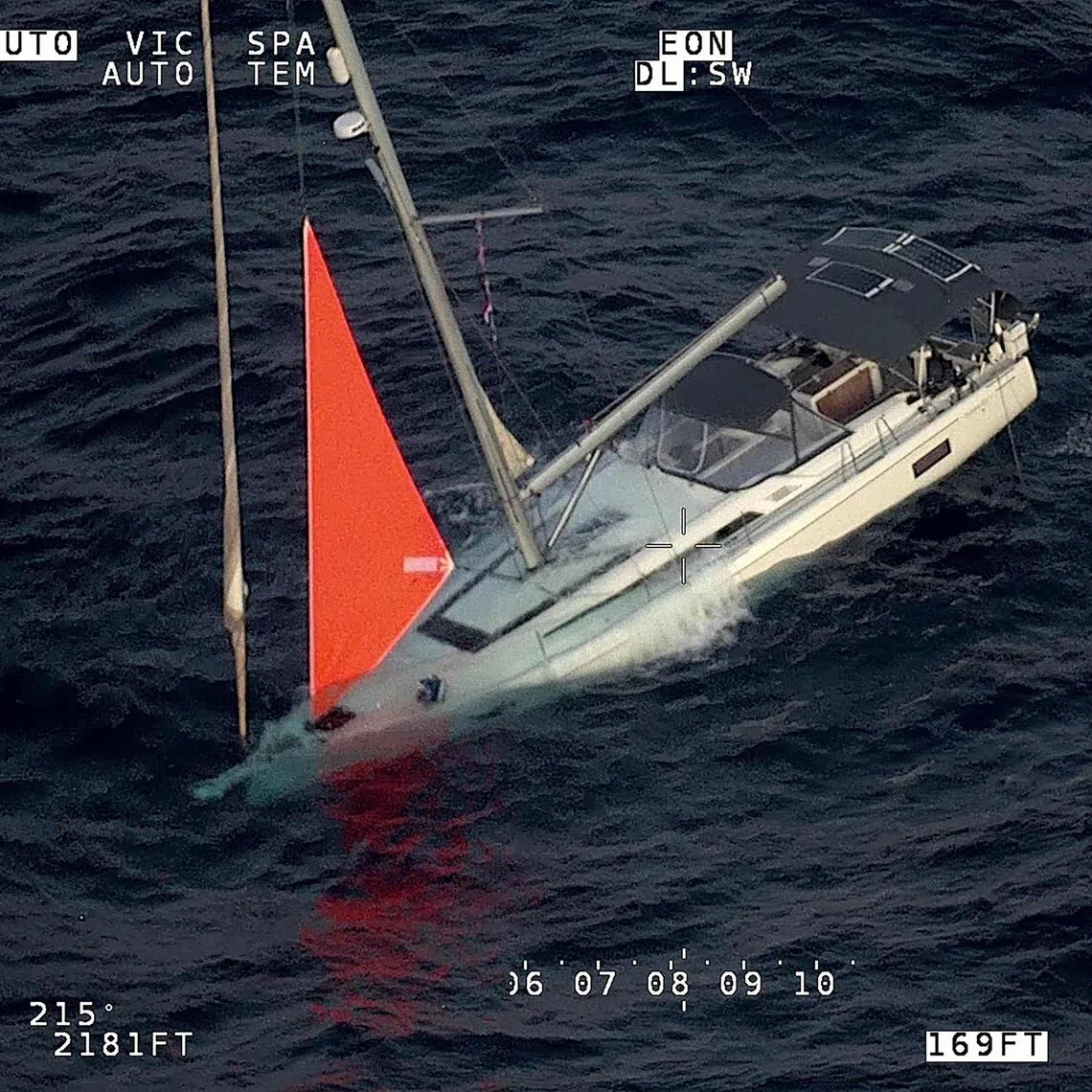 This handout image taken on Sept 26 shows a yacht sinking after a sperm whale struck and cracked the hull in the remote South Pacific.