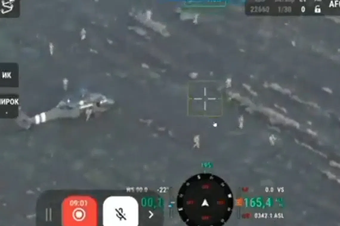 A video posted online shows at least 10 servicemen dismounting from a helicopter in a field.