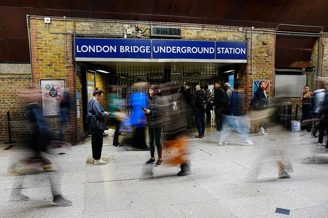 Pedestrians pass one of the closed entrances to London Bridge Underground Station in London on September 8, 2025, as most of London Underground services are suspended during strike action by members of the Railway workers' union RMT. London has been hit by a week-long strike on its underground railway the Tube, after unions and management failed to reach a pay deal. Thousands of Tube staff are to carry out the network's biggest strike for three years, with the worst of the disruption expected Monday to Thursday. (Photo by CARLOS JASSO / AFP)