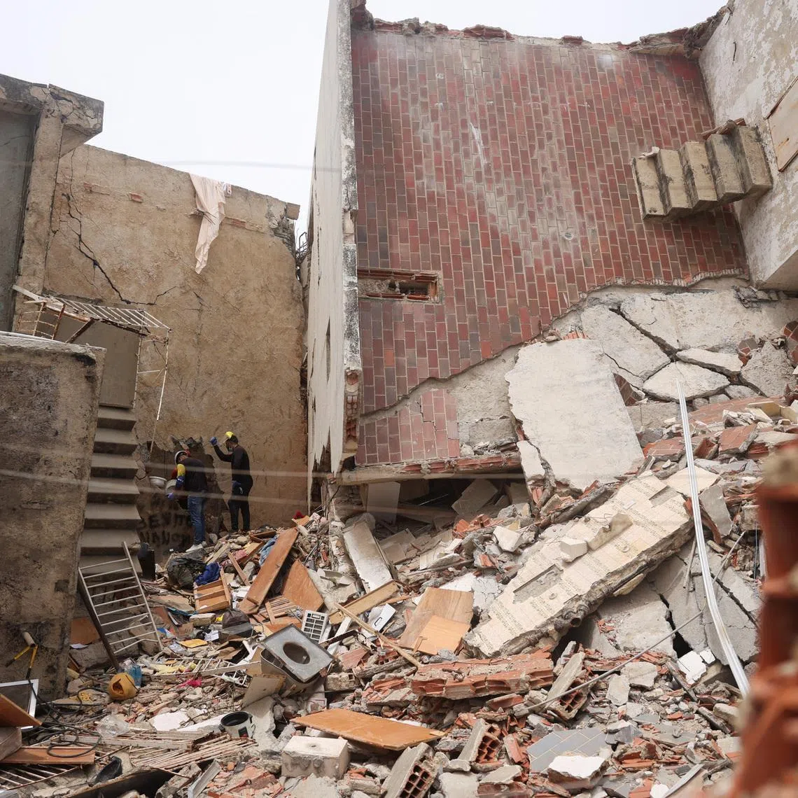 Rescuers work at the site of a collapsed building in the aftermath of the June 24 earthquakes in Caraballeda, La Guaira, Venezuela, July 5, 2026. REUTERS/Leonardo Fernandez Viloria