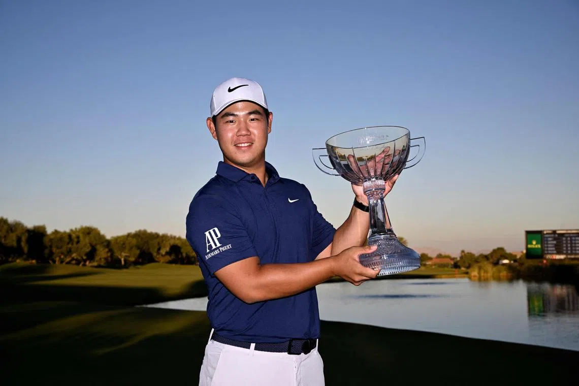 Tom Kim of South Korea posing with the trophy after putting in to win on the 18th green during the final round of the Shriners Children's Open at TPC Summerlin in Las Vegas on Sunday.