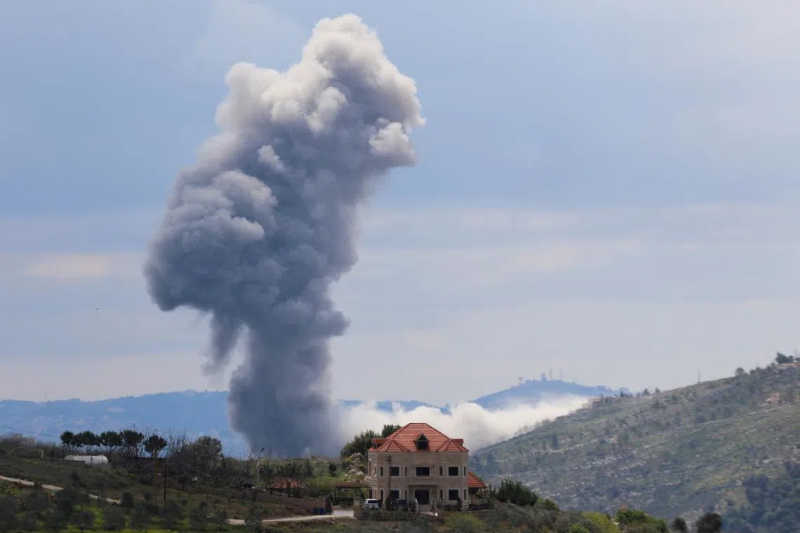 FILE PHOTO: Smoke rises from Taibeh, following Israeli strikes in response to cross-border rocket fire, as seen from Marjayoun in southern Lebanon, March 22, 2025. REUTERS/Karamallah Daher/File Photo