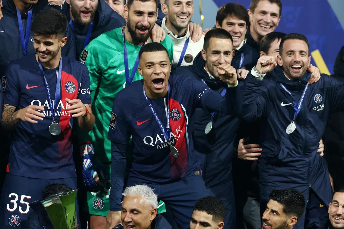 Paris Saint-Germain's Kylian Mbappe celebrating with teammates after winning the French Super Cup.