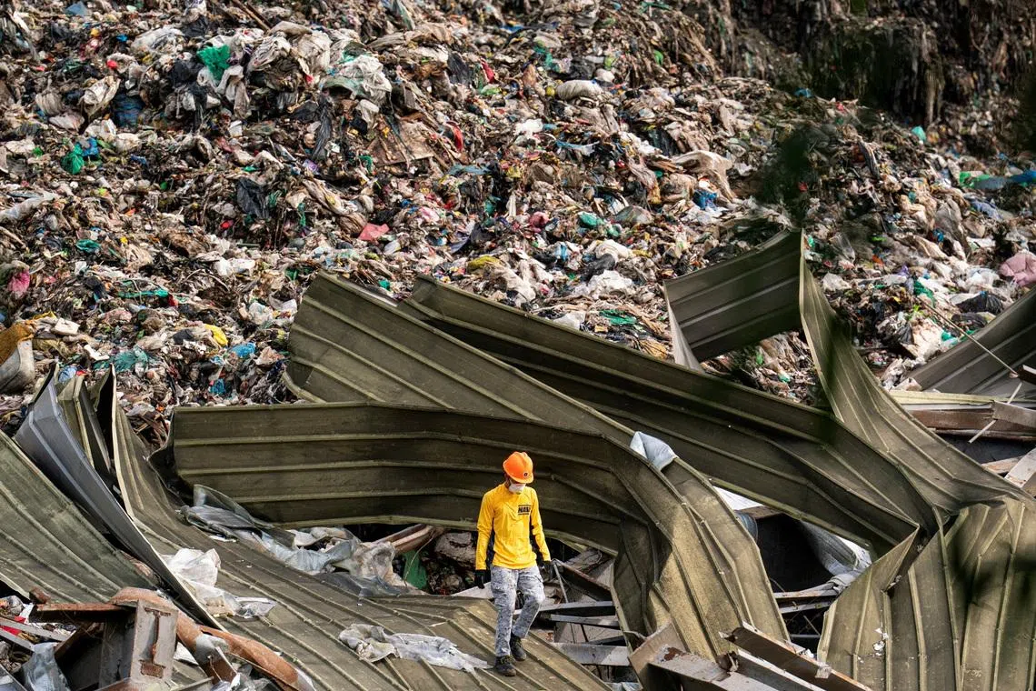 A rescue worker conducting a rescue operation at the collapsed landfill in Binaliw, Cebu, Philippines, on Jan 11, 2026. 