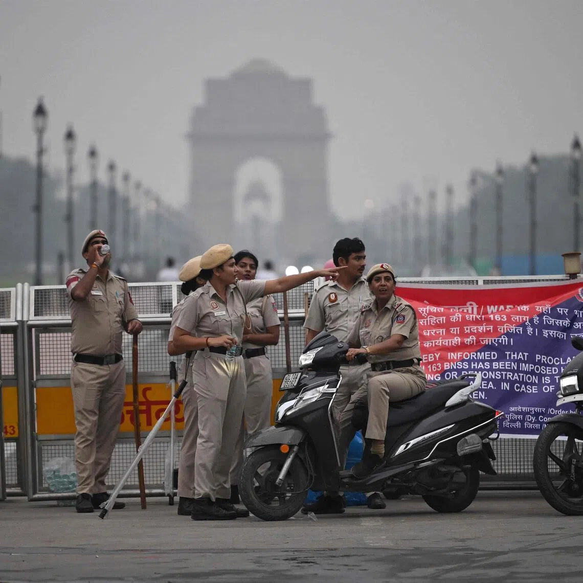 Delhi Police personnel stand guard near the India Gate in New Delhi on Oct 10, ahead of a protest by the youth-led Cockroach Janata Party.