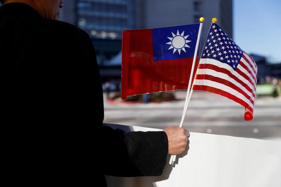 A demonstrator holds flags of Taiwan and the United States in support of Taiwanese President Tsai Ing-wen during an stop-over after her visit to Latin America in Burlingame, California, U.S., January 14, 2017. REUTERS/Stephen Lam/ File Photo