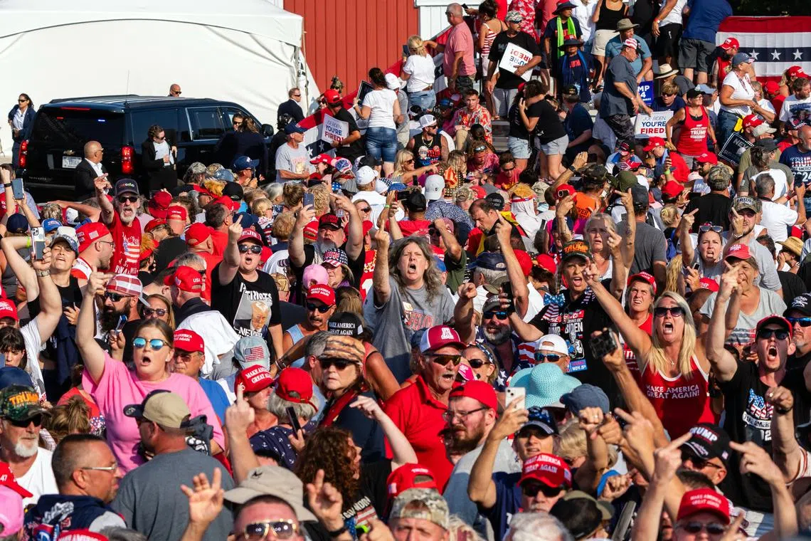Supporters of former US President Donald Trump react as he is escorted off the stage at a campaign rally in Butler, Pennsylvania, on July 13, 2024. 