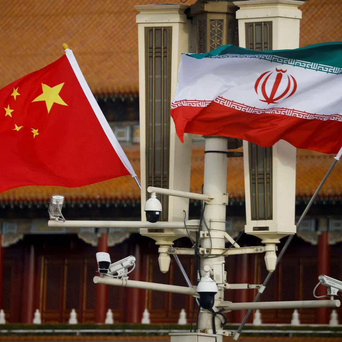 The national flags of China and Iran fly in Tiananmen Square, Beijing, China, February 14, 2023. REUTERS/Thomas Peter/File Photo