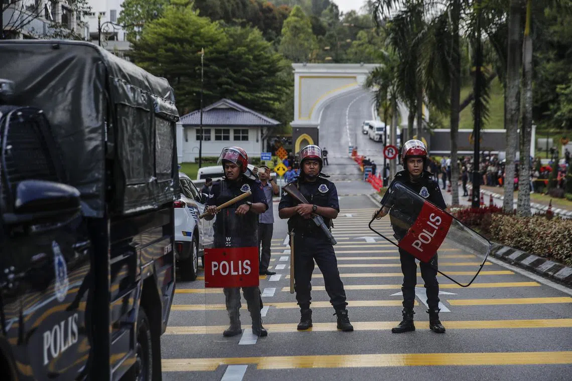 Unit officers from Royal Malaysia Police guard the entrance of National Palace in Kuala Lumpur on Nov 22, 2022.