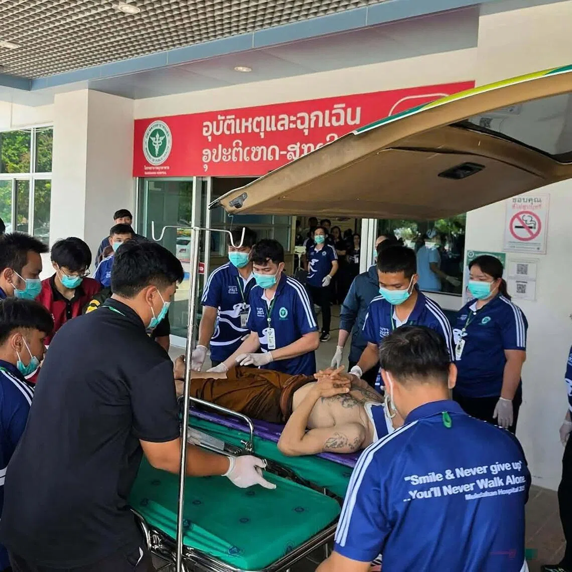 An injured monk arrives at Mukdahan Hospital after a collision between a pickup truck driven by an 11-year old and a procession of Buddhist monks, in the north-eastern Thai province of Mukdahan on July 2.