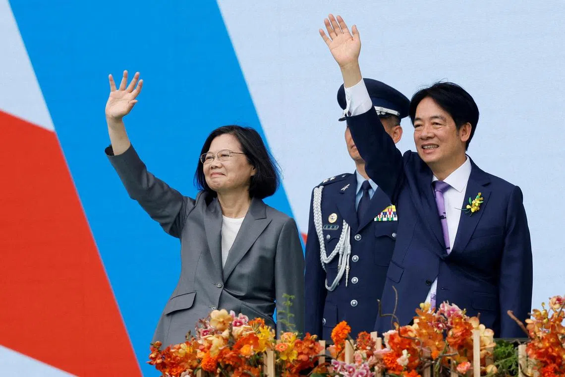 Taiwan's former President Tsai Ing-wen and new President Lai Ching-te wave to people during the inauguration ceremony outside the Presidential office building in Taipei, Taiwan May 20, 2024. REUTERS/Carlos Garcia Rawlins     TPX IMAGES OF THE DAY/