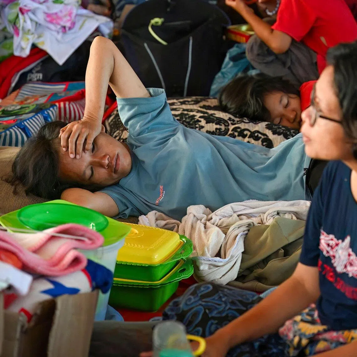 Villagers who lost their homes due to flash floods rest at a shelter at Tukka village in North Sumatra.