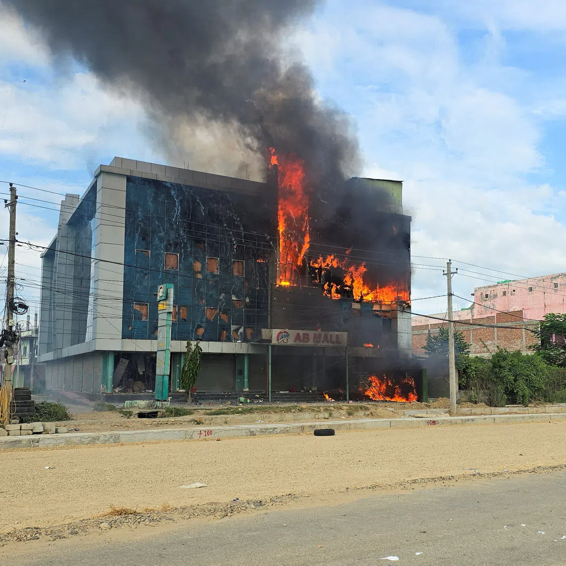 Smoke and fire rise from a mall after it was vandalised following a clash between two communities in Siraha, Nepal on July 30.