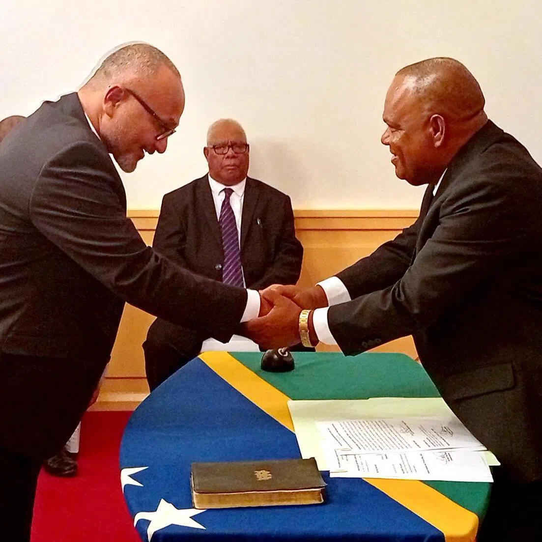 Solomon Islands' new prime minister Matthew Wale (left) is sworn in by Governor-General David Kapu at Government House. 