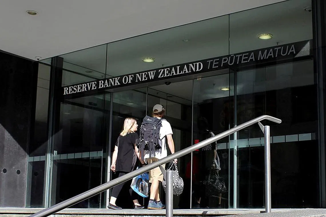 FILE PHOTO: Two people walk towards the entrance of the Reserve Bank of New Zealand located in the New Zealand capital city of Wellington, March 22, 2016. REUTERS/Rebecca Howard/File Photo