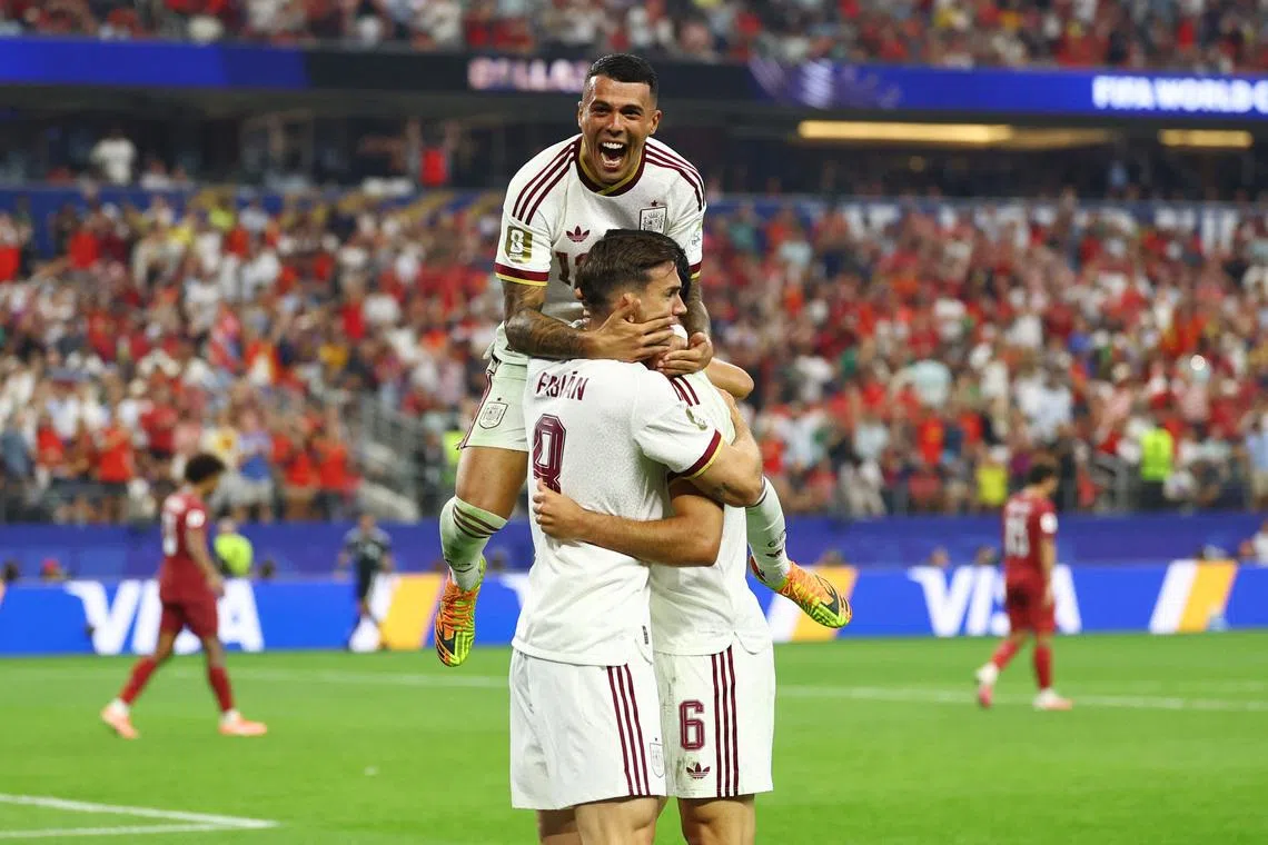 Spain’s Mikel Merino celebrates scoring their first goal against Portugal with Fabian Ruiz and Pedro Porro.