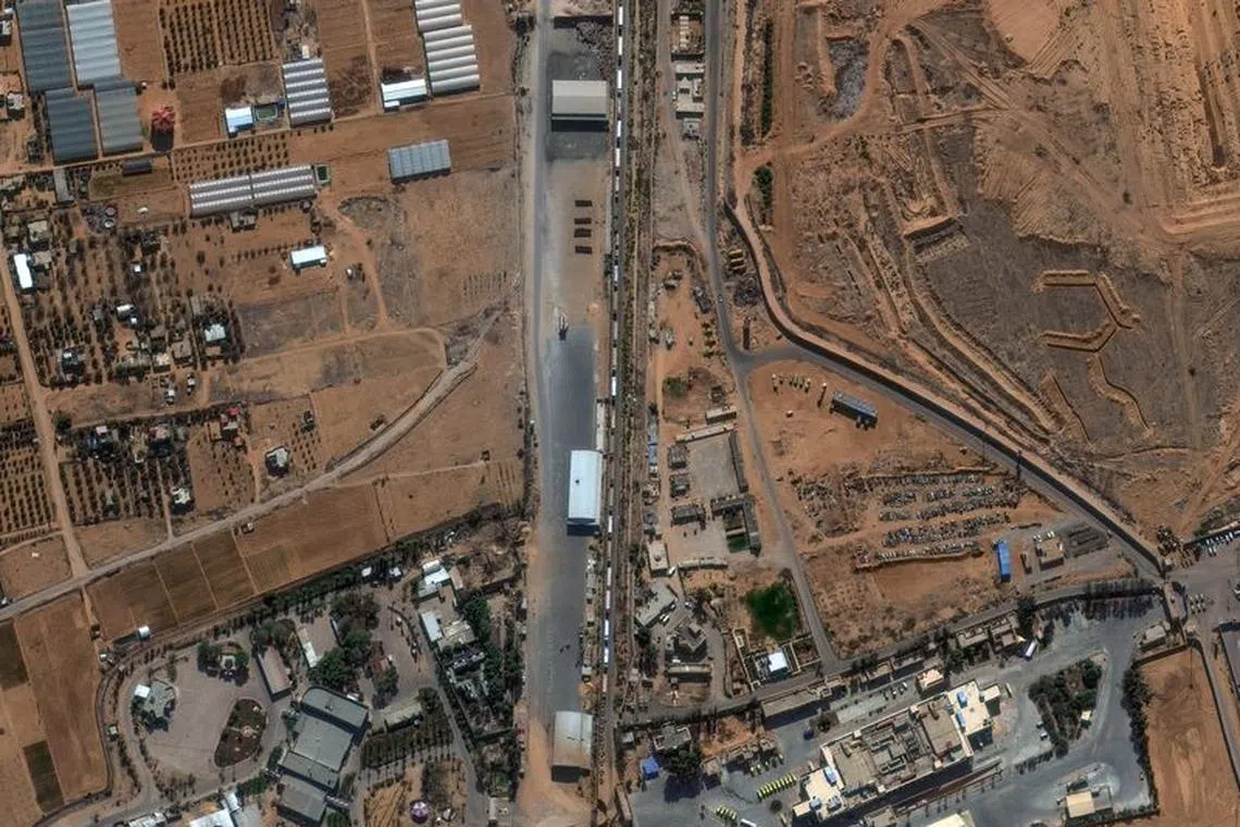 A satellite image shows humanitarian-associated trucks queueing to enter the Rafah border crossing between Gaza and Egypt, amid the ongoing conflict between Israel and the Palestinian Islamist group Hamas, November 7, 2023. Maxar Technologies/Handout via REUTERS