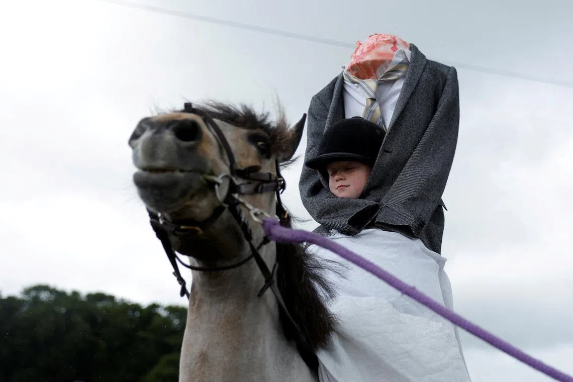 Sophie Hawkshaw, nine, dressed as a Headless Horseman participating in a fancy dress competition for riders under 10 years old, at an agricultural show in Athenry, Ireland, May 25, 2025. 
