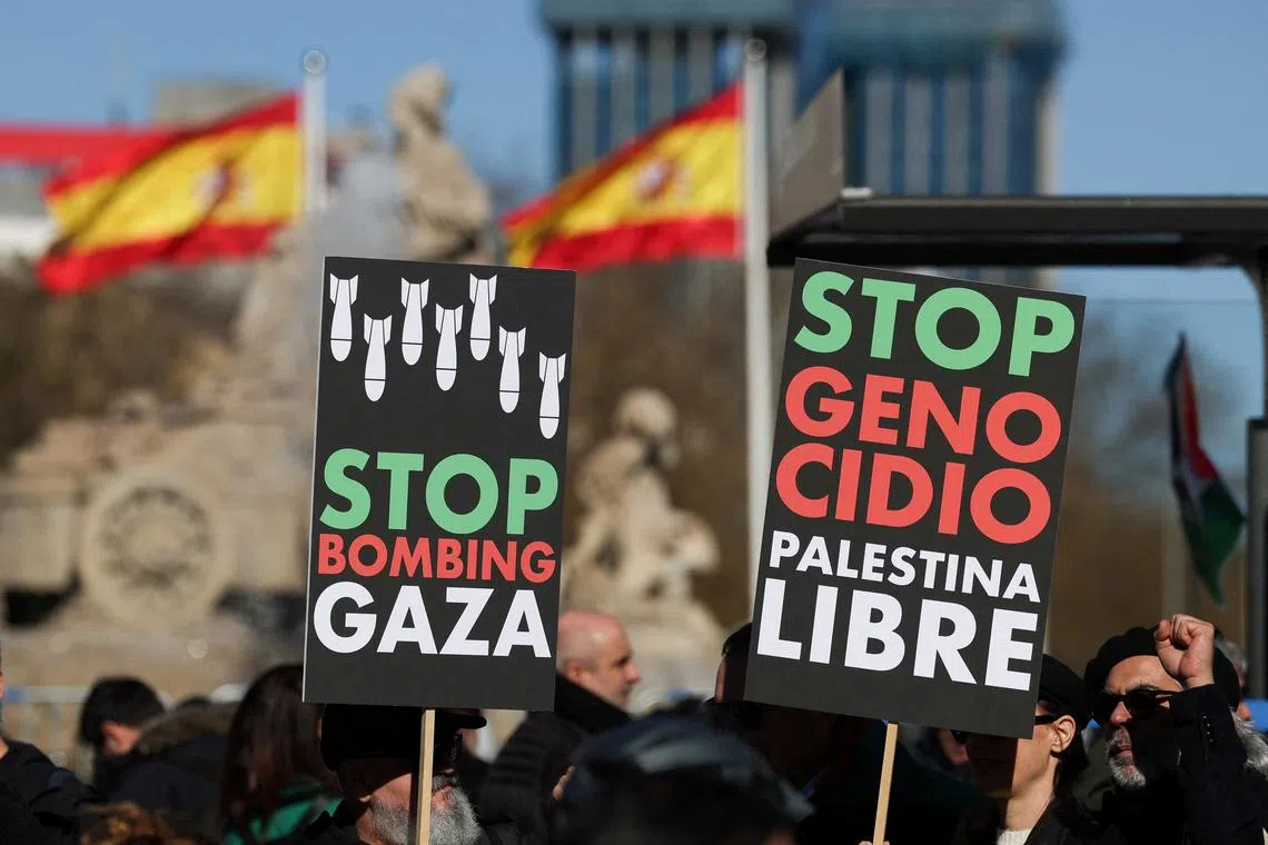 FILE PHOTO: People hold anti-war placards during a protest to call for a ceasefire in Gaza to mark 100 days since the start of the conflict between Israel and the Palestinian Islamist group Hamas, in Madrid, Spain, January 20, 2024. REUTERS/Isabel Infantes/File Photo