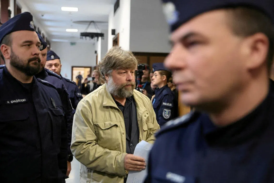 FILE PHOTO: Russian archaeologist Alexander Butyagin, who is accused by Ukraine of unauthorised excavation and plundering of historical artefacts in Crimea, is escorted by Polish police as he arrives at a district court in Warsaw, Poland, January 15, 2026. Robert Kowalewski/Agencja Wyborcza.pl via REUTERS