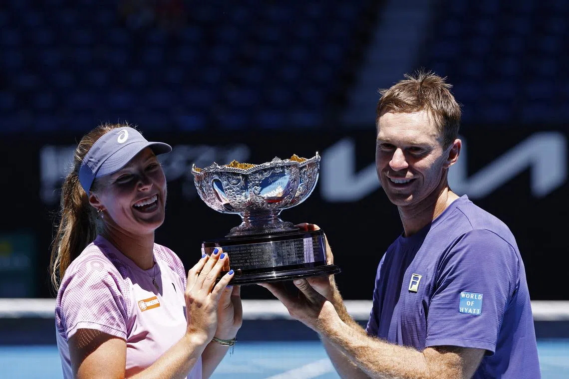 Tennis - Australian Open - Melbourne Park, Melbourne, Australia - January 24, 2025 Australia's Olivia Gadecki and John Peers pose with the trophy after winning the mixed doubles final REUTERS/Kim Kyung-Hoon