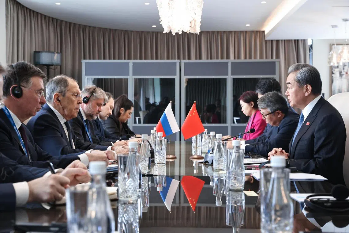 China's top diplomat Wang Yi (right) meeting Russian Foreign Minister Sergei Lavrov (second from left) on the sidelines of the G-20 foreign ministers' meeting in Johannesburg, South Africa, on Feb 20.