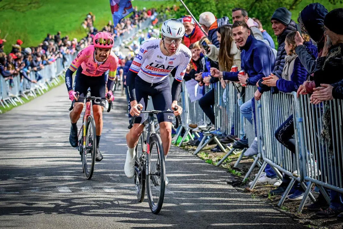 UAE Team Emirates' Slovenian cyclist Tadej Pogacar (in white) leading ahead of EF Education-EasyPost's Ecuadorian rider Richard Carapaz in the Liege-Bastogne-Liege one-day race.