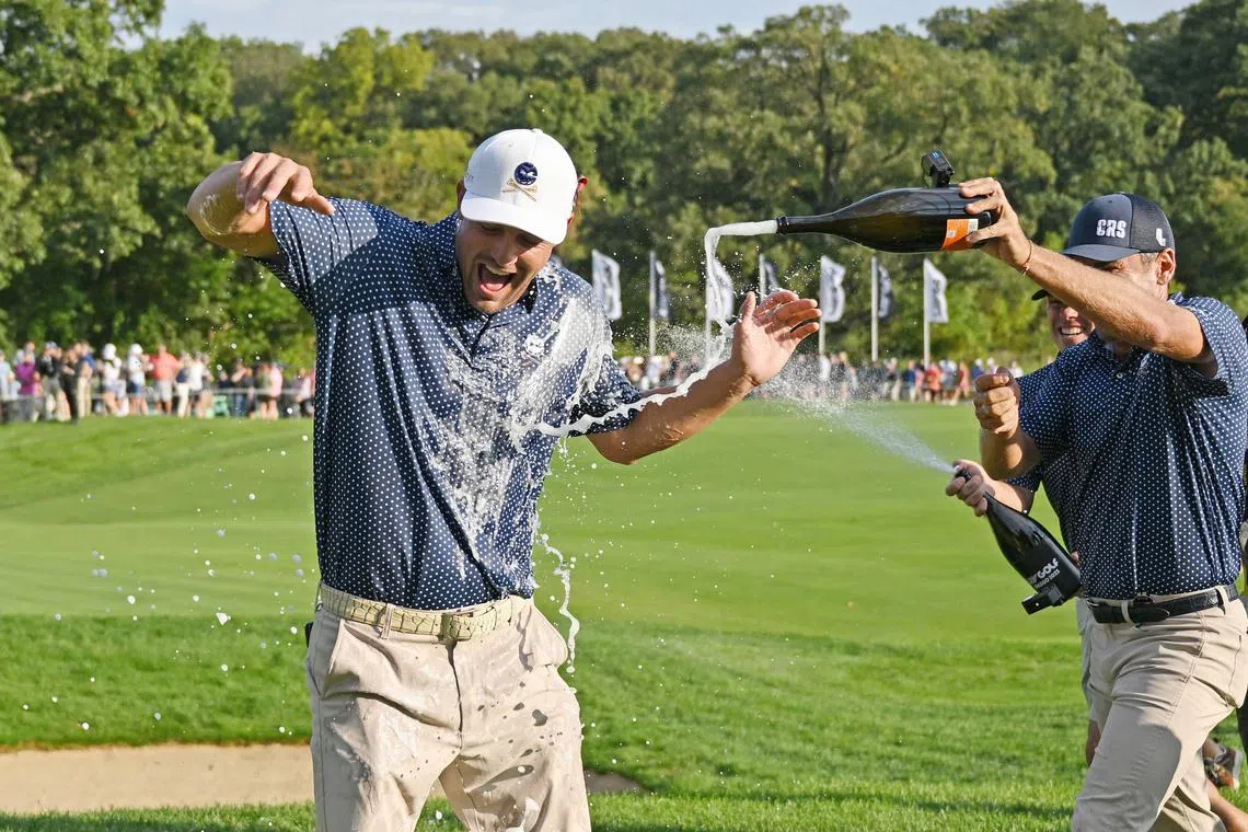 Bryson DeChambeau is doused in champagne after winning the LIV Golf Invitational outside Chicago.