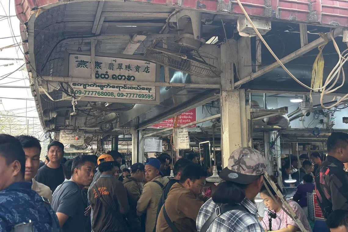 Chinese brokers shine LED torches and peer through magnifying glasses to appraise items from uncut stones to finished pieces of jewellery.