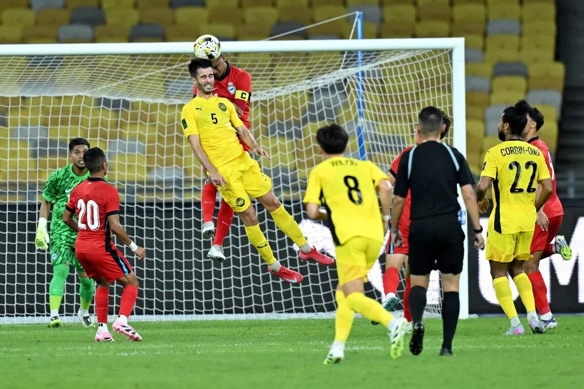 Singapore's Safuwan Baharudin challenging Malaysia's Jon Irazabal Iraurgui for the ball during a friendly in Kuala Lumpur on Sept 4.