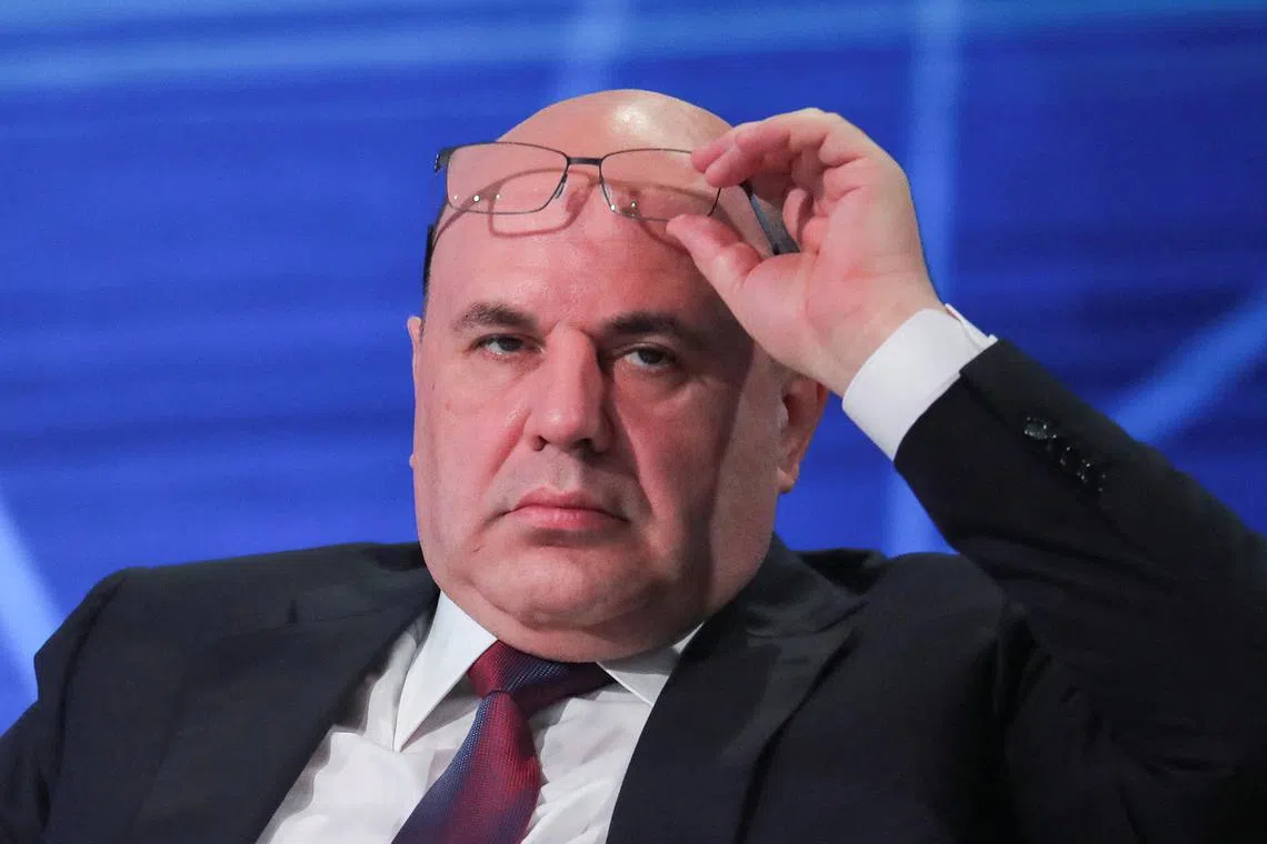 FILE PHOTO: Russian Prime Minister Mikhail Mishustin adjusts glasses as he attends Digital Almaty 2024 forum in the city of Almaty, Kazakhstan, February 2, 2024. REUTERS/Pavel Mikheyev/File Photo