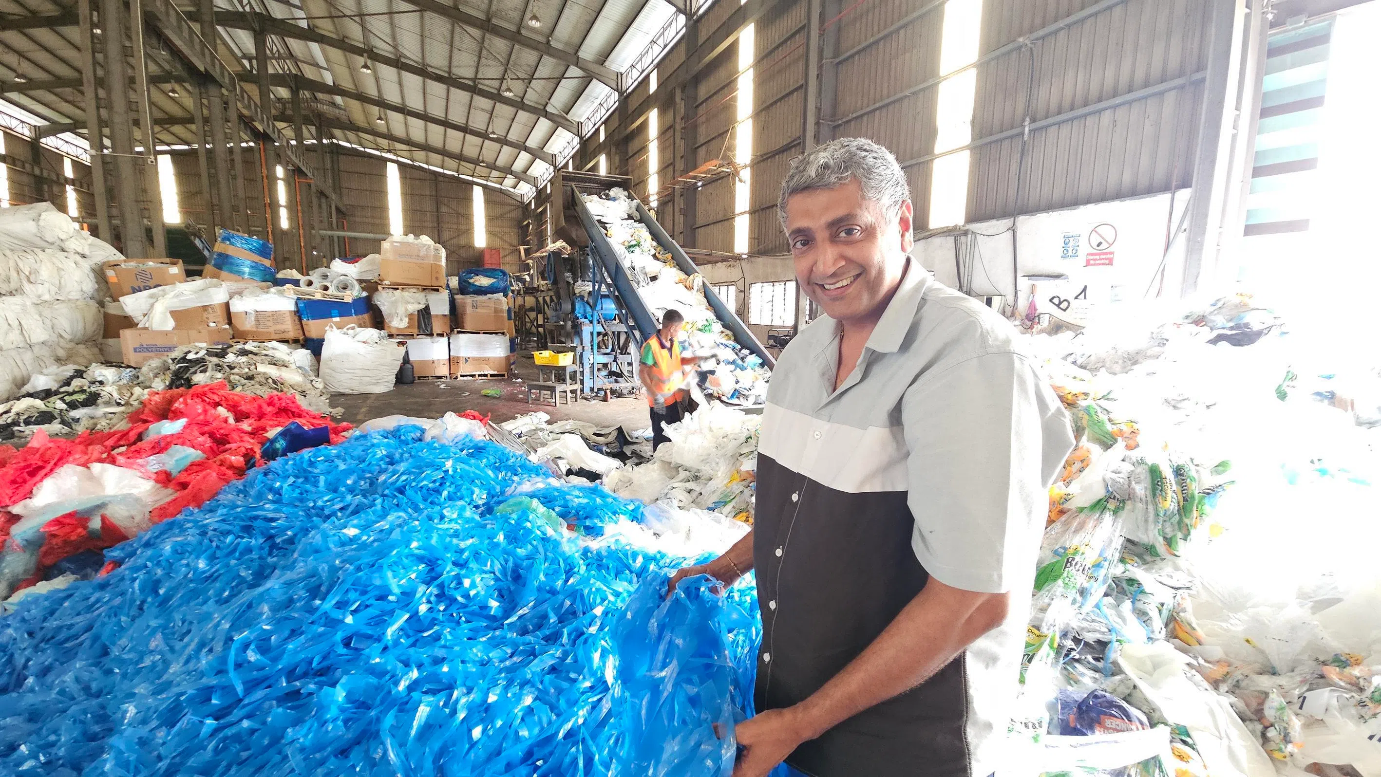 Mr G. Aushal, managing director of Sannanda Rika, with plastic waste feedstock for recycling into low-density polyethylene.