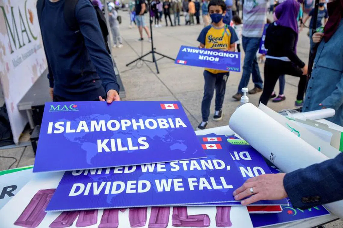 FILE PHOTO: Attendees return signs after a rally to highlight Islamophobia, sponsored by the Muslim Association of Canada, including the June 6 in London, Ontario attack which killed a Muslim family in what police describe as a hate-motivated crime, in Toronto, Ontario, Canada June 18, 2021. REUTERS/Alex Filip/File Photo