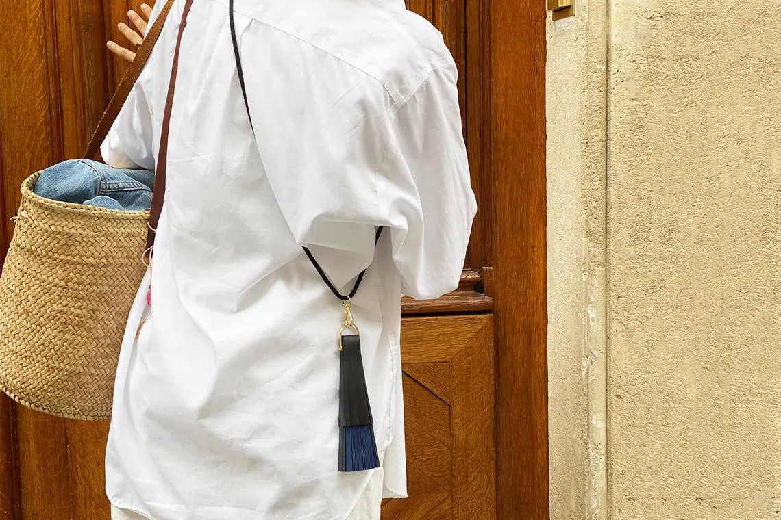 In a photo provided by Duvelleroy shows, DuvelleroyÕs Take Away fan which comes with a cord so it can be worn like a purse. When temperatures rise from steamy to sweltering, as they have lately in much of the world, pulling out a fan can make a more universal statement: ItÕs way too hot out. (Duvelleroy via The New York Times) -- NO SALES; FOR EDITORIAL USE ONLY WITH NYT STORY HAND FANS STYLE BY HILARY REID FOR JULY 26, 2023. ALL OTHER USE PROHIBITED. --