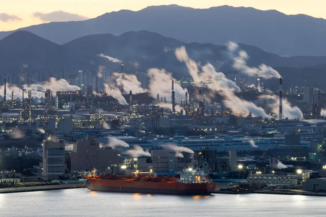 Water vapor and smoke rise from an industrial complex at sunset in Ulsan, South Korea, on Tuesday, Jan. 23, 2024. South Korea’s simmering credit risks weighed on construction activity last quarter, holding economic growth in check even as exports maintained momentum and adding to concerns for President Yoon Suk Yeol ahead of parliamentary elections crucial to his policy initiatives. Photographer: SeongJoon Cho/Bloomberg