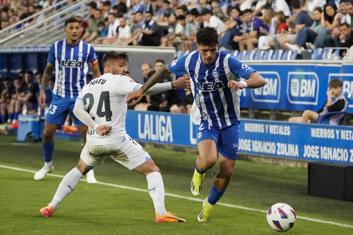 Alaves defender Javi Lopez getting past Girona striker Portu in the Spanish La Liga match in Vitoria on May 10, 2024.