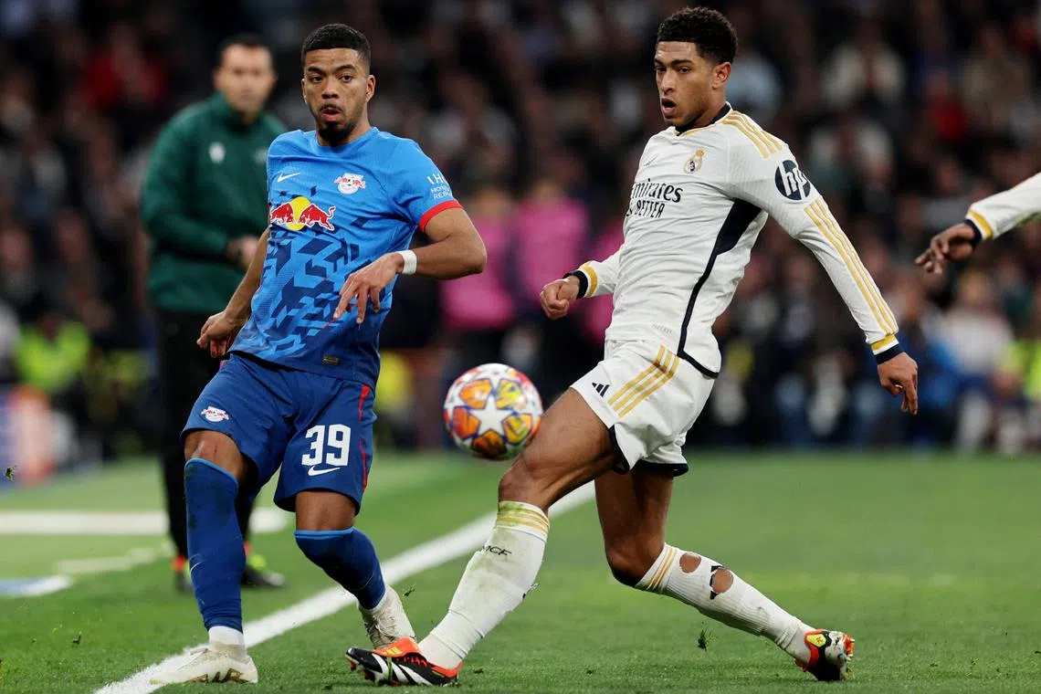 Soccer Football - Champions League - Round of 16 - Second Leg - Real Madrid v RB Leipzig - Santiago Bernabeu, Madrid, Spain - March 6, 2024 RB Leipzig's Benjamin Henrichs in action with Real Madrid's Jude Bellingham REUTERS/Violeta Santos Moura
