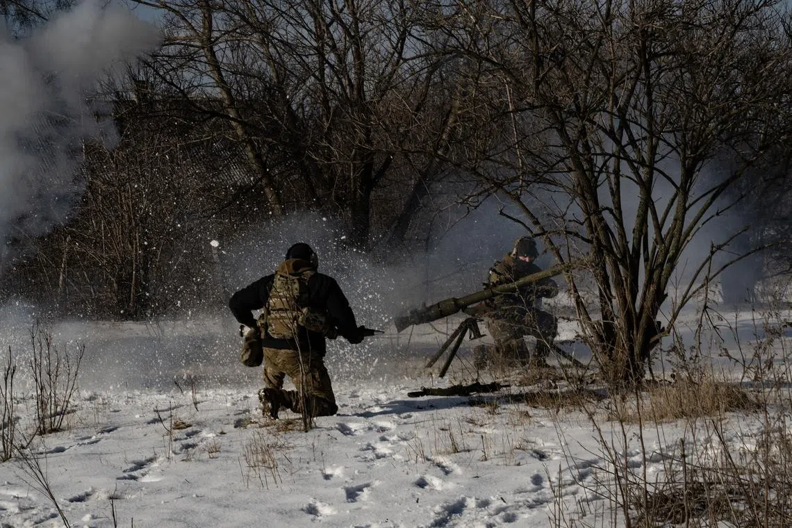 Soldiers from the Free Russia Legion fire against Russian positions along the front line in the Donbas region.