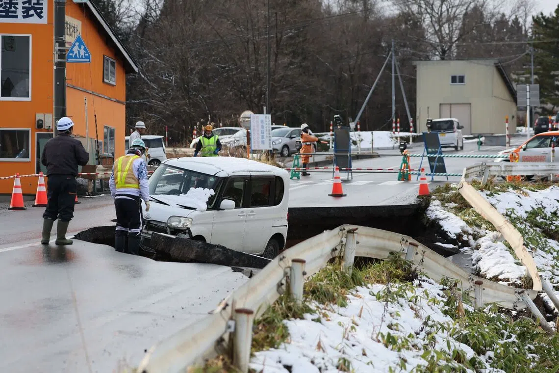 A vehicle is seen on a collapsed road in Tohoku town in Aomori Prefecture, on Dec 9.